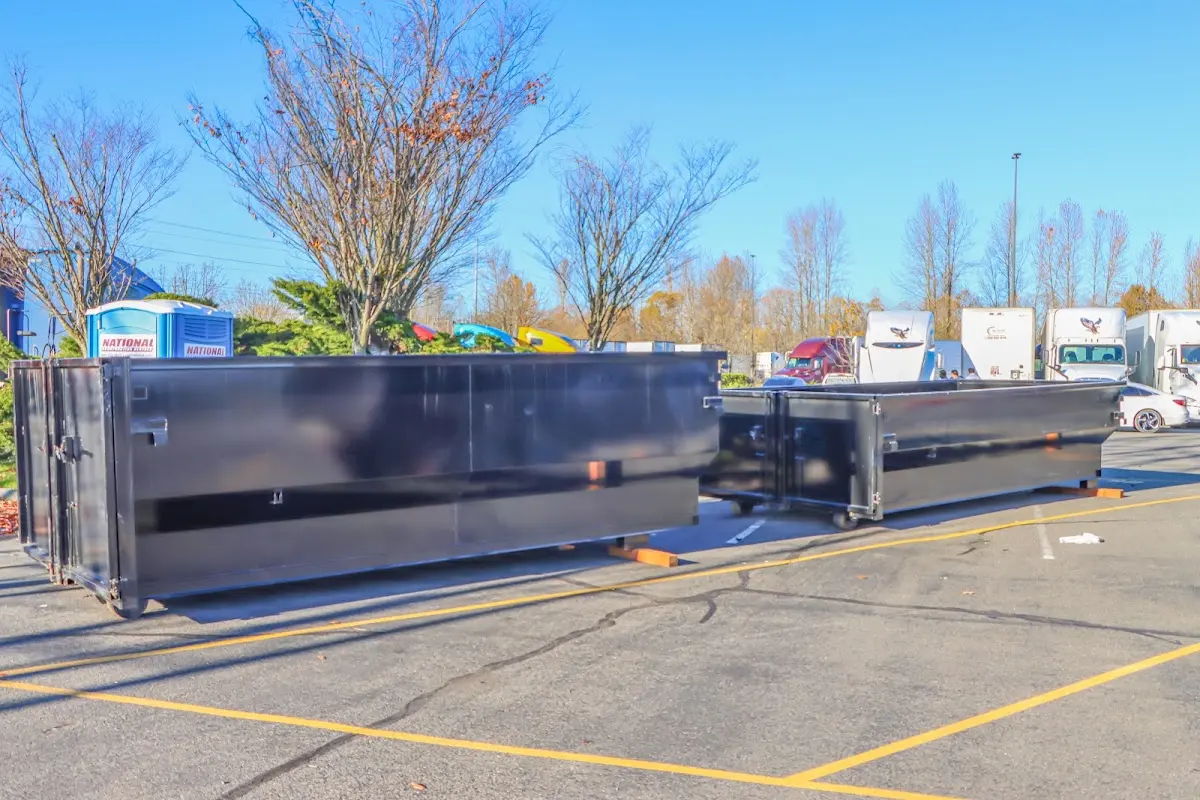 Professional dumpster rental service with roll-off container on residential driveway in George Mason